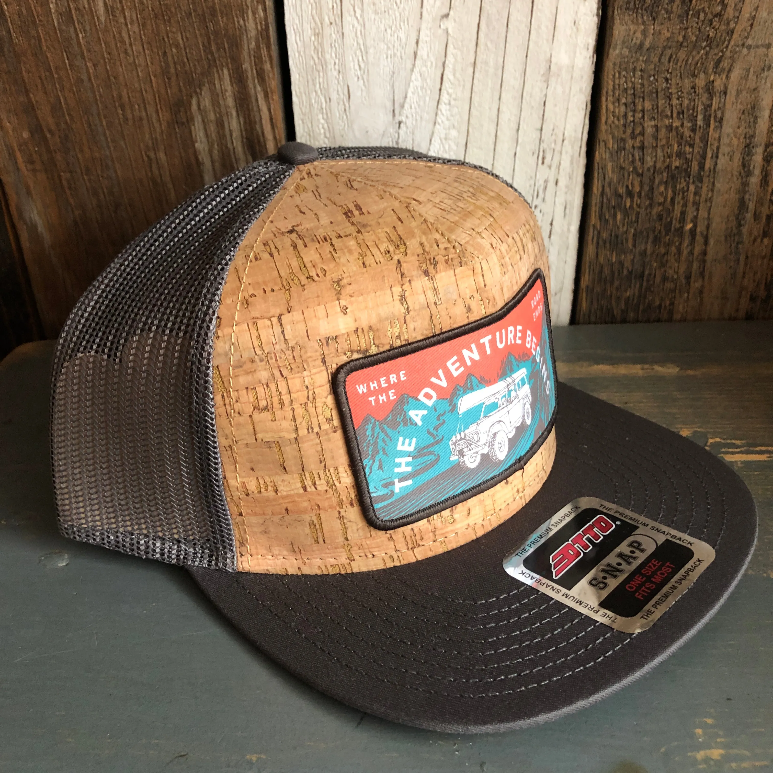 WHERE THE ROAD ENDS, THE ADVENTURE BEGINS Premium Cork Trucker Hat (Grey)